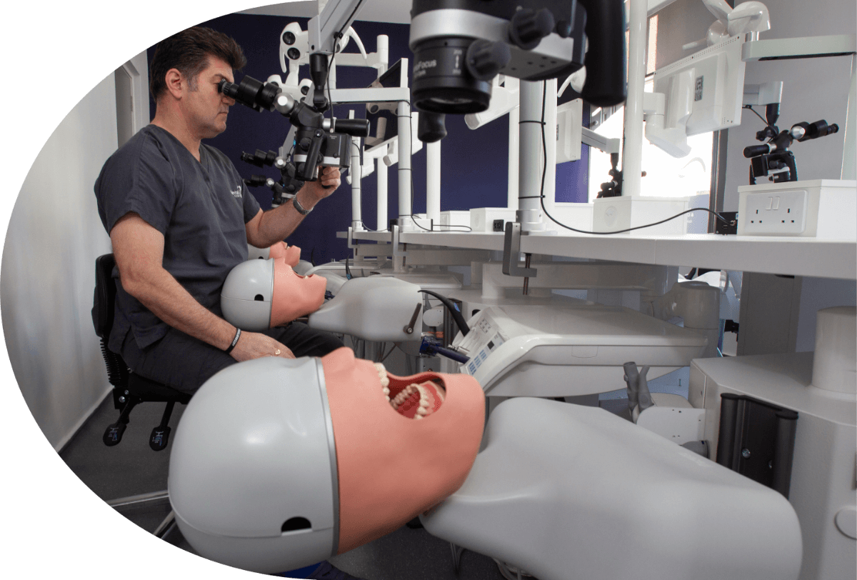 A person looking in a microscope with mannequins with their mouths open